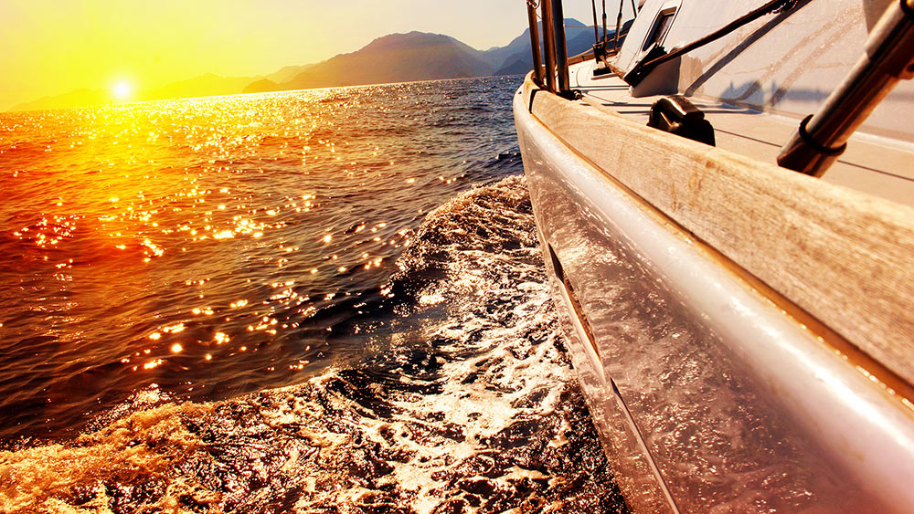 sailboat sailing to the island of freedom